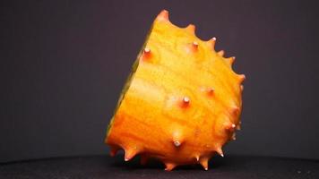 Ripe kiwano on a black background twirl video