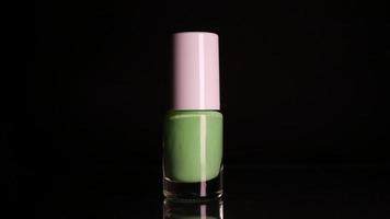 Green neon nail polish on black background video