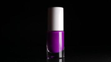 Purple neon nail polish on black background video