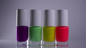 Four neon nail polishes stand in a row video