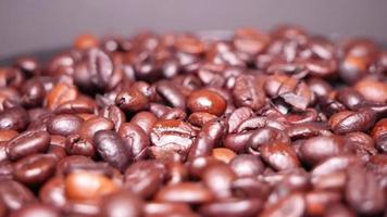 Freshly roasted coffee beans close up video