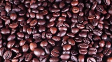 Freshly roasted coffee beans close up video