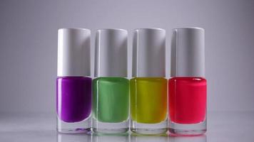 Four neon nail polishes stand in a row video