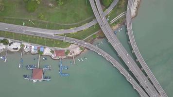 Aerial view busy traffic interchange beside sea video
