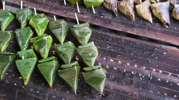 Delicious food sata is barbecue of meat wrap in palm leaves video