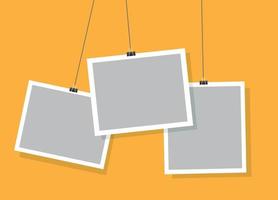 Realistic simple hanging photo frames design with yellow vector background