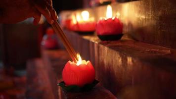 Select focus hand hold incense stick burn at candle light video