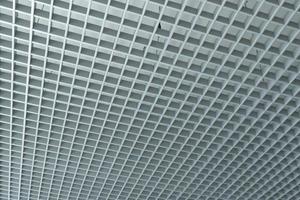 grid ceiling background is beautiful because it is designed to cover traces of original ceiling resulting in modern grid ceiling pattern. backdrop of ceiling is decorated with steel in grid pattern. photo