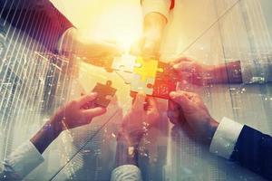 Teamwork of partners. Concept of integration and startup with puzzle pieces. double exposure photo