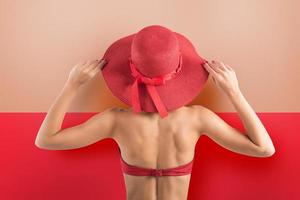 niña vestidos un traje de baño y sombrero en rojo estilo foto