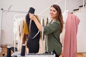 Seamstress works to new clothes ordered by internet client photo