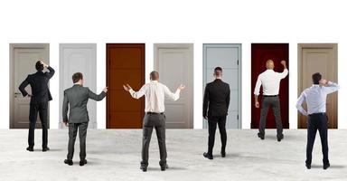 Business people looking to select the right door. Concept of confusion and competition photo