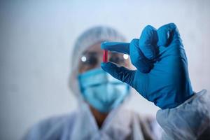 Pharmaceutical researcher finds a solution to coronavirus. Concept of medical research photo