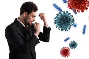 Businessman fights like a boxer. Concept of viruses and bacteria attack photo
