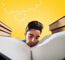 Exhausted student is studying hard on the desk photo