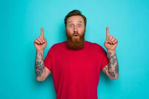 Man is wondered and indicates something with hand photo