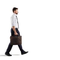 Businessman walks on white background photo