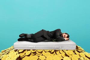 Businessman sleeps serene over a pile of golden coins. concept of wealth and good investment photo