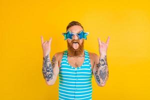 man with beard,tattoos and swimsuit is ready for the summer photo