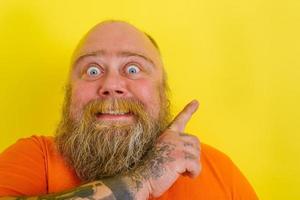 Afraid man with beard and tattoos is worried about something photo