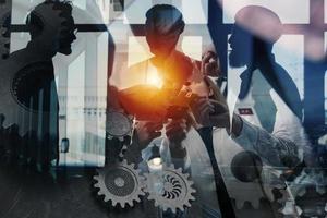 Teamwork of partners. Concept of integration and startup with puzzle pieces and gear overlay. double exposure photo
