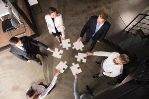 Teamwork of partners. Concept of integration and startup with puzzle pieces photo