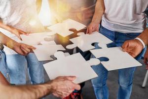 Teamwork of partners connect puzzle pieces as integration and startup photo