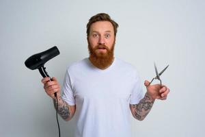 Wondered man with hair straightener is ready to work photo