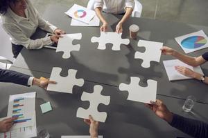 Teamwork of partners. Concept of integration and startup with puzzle pieces photo