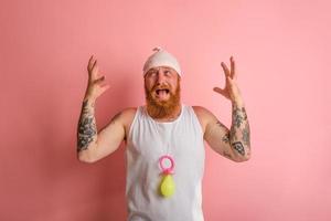 Cry man with beard and tattoos acts like a small newborn photo