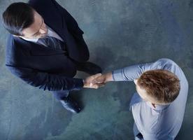 Handshaking business person in office. concept of teamwork and partnership photo