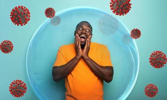 Man inside a glass sphere is secure and protected against covid19 coronaviruses. photo