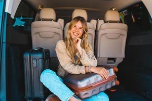 Woman is ready to travel with baggages in hand photo