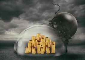 Coins safely inside a shield dome during a storm that protects them from a wrecking ball. Protection and safety concept photo