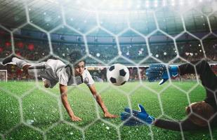 Goalkeeper catches the ball in the stadium during a football game. photo