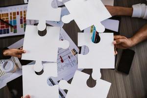 Teamwork of partners. Concept of integration and startup with puzzle pieces photo