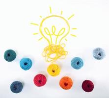 Concept of idea and innovation with wool ball that shapes a lightbulb photo