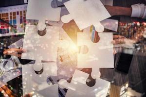 Teamwork of partners. Concept of integration and startup with puzzle pieces photo