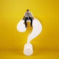 Man sitting on top of a big white question mark on a yellow background photo