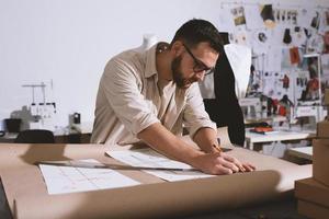 Seamstress works to new clothes ordered by internet client photo