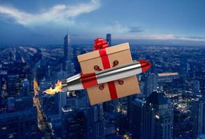 Christmas Gift flies fast by a power rocket over a city photo