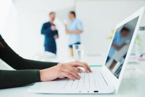 Girl works on a laptop. Concept of internet sharing and interconnection photo