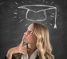 Blonde woman student thinks about her graduation photo