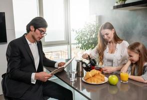 Happy family have a breakfast at home photo