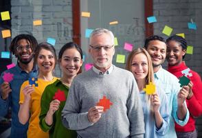 Teamwork of partners that work together. Concept of integration and startup with colored puzzle pieces photo