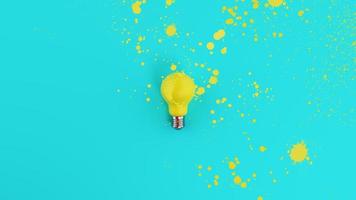 Yellow lightbulb with spray effect on cyan background. Concept of creativity and idea photo