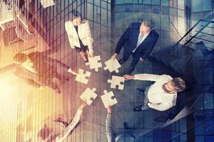 Teamwork of partners. Concept of integration and startup with puzzle pieces photo