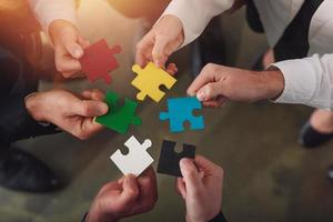 Teamwork of partners connect puzzle pieces as integration and startup photo