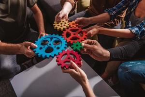 Business team connect pieces of gears. Teamwork, partnership and integration concept photo
