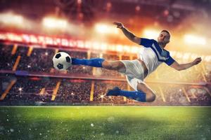 Soccer striker hits the ball with an acrobatic kick photo